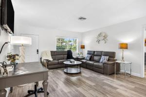 a living room with a couch and a table at Buffalo Bungalow in Clearwater Beach