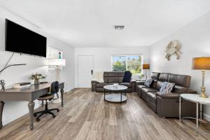 a living room with a couch and a table at Buffalo Bungalow in Clearwater Beach