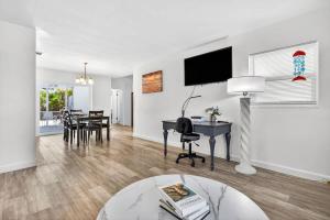 a living room with a desk and a table at Buffalo Bungalow in Clearwater Beach