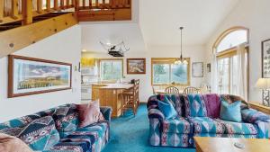 a living room with a couch and a table at Spring Mountain Condo Pool Gym Slopes in McCall