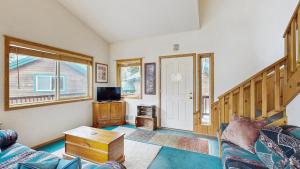 a living room with a couch and a tv at Spring Mountain Condo Pool Gym Slopes in McCall