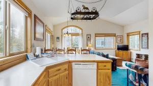 a kitchen with a sink and a living room at Spring Mountain Condo Pool Gym Slopes in McCall