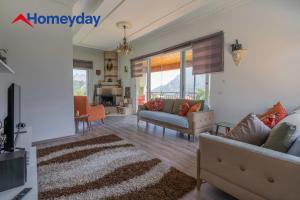 a living room with two couches and a fireplace at Villa Mountain with Pool in Gedeller