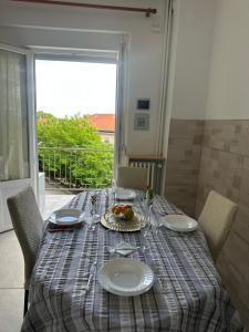 a table with a plate of food on top of it at Central City Apartment of Asti in Asti