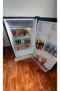 an open refrigerator filled with lots of food and drinks at Quarto privativo in Telêmaco Borba
