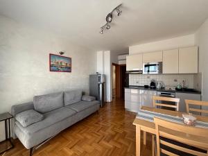 a living room with a couch and a kitchen at Apartmani Cindrić in Stara Baška +11 photos