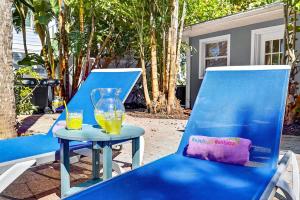 two blue chairs and a table with two glasses of orange juice at Lantana Cabana in Clearwater Beach