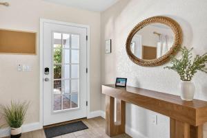 a hallway with a mirror and a wooden table at Lantana Cabana in Clearwater Beach