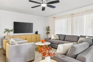 a living room with couches and a flat screen tv at Lantana Cabana in Clearwater Beach
