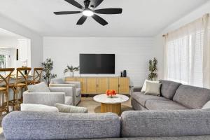 a living room with a couch and a ceiling fan at Lantana Cabana in Clearwater Beach