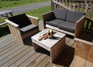 a bench and a chair and a table on a deck at F1 Weekend House Close to Spa 6 Guests Doc in Amblève