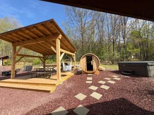 a wooden pavilion with a tub in a yard at Cozy Log Cabin in Jim Thorpe in Jim Thorpe