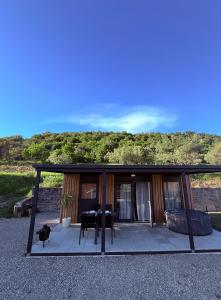 a house with a screened in porch with a piano at Mobile House Aurora with whirlpool in Ankaran