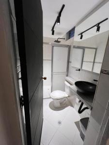 a small bathroom with a toilet and a sink at Hotel Gran Imperio la 69 in Medellín +31 photos