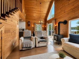 a living room with wood paneling and a staircase at Le Malpic in Mont-Laurier