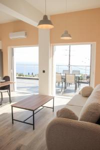 a living room with a couch and a table at Zeus Cosmos Apartments in Lourdata