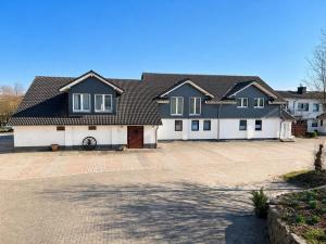 a large house with a driveway in front of it at Pension Pohl in Wenden