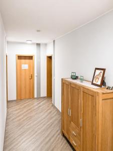 an empty room with a wooden cabinet and a door at Pension Pohl in Wenden