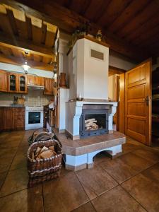a living room with a fireplace in a kitchen at Chalupa pod Skleným Vŕškom in Huty