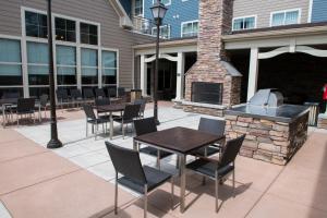 a patio with tables and chairs and a brick oven at Residence Inn by Marriott Helena in Helena