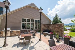 a patio with a table and chairs and a grill at Residence Inn by Marriott Helena in Helena +51 photos
