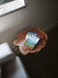 a book sitting on top of a wooden table at Cherry Douro Hill in Resende