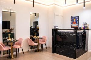 a restaurant with pink chairs and tables in a room at Museo Suite in Naples