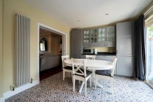a kitchen with a white table and chairs in a room at Phoenix House in Dublin