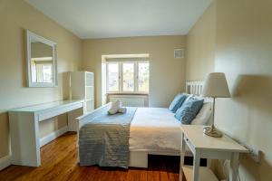 a small bedroom with a bed and a table at Phoenix House in Dublin