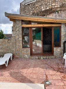 a patio with a bench and a stone wall at Casa Angel in Cazorla
