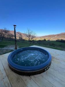 a hot tub sitting on top of a wooden table at VaavHouse in Tyudov