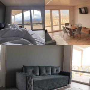 a living room with a couch and a bed and a table at VaavHouse in Tyudov