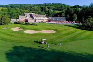an aerial view of a golf course with a house at Partridge Hill House in Hartford
