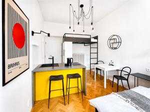 a kitchen with a yellow island in a room at Botanique Rooms with Sauna by Homester in Brno