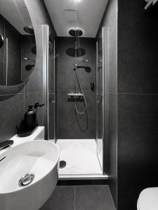 a bathroom with a shower and a sink at Botanique Rooms with Sauna by Homester in Brno +35 photos