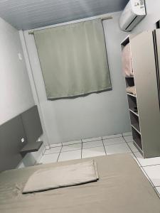 a room with a window and a bed in it at Hotel Real in Realeza