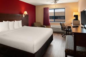 a hotel room with a bed and a desk and a computer at Bay Breeze Inn in Seaside