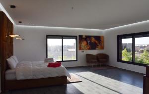 a bedroom with a bed and two windows at Villa Dar SAYF in Najem +29 photos