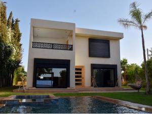 a house with a swimming pool in front of it at Villa Dar SAYF in Najem