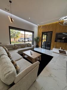 a living room with a couch and a table at Villa Dar SAYF in Najem