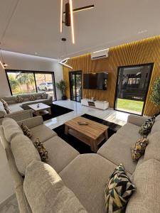 a living room with two couches and a tv at Villa Dar SAYF in Najem