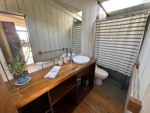 a bathroom with a sink and a toilet at Cabañas La Ola Puertecillo in Navidad +25 photos