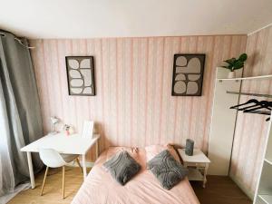 ein Schlafzimmer mit einem Bett, einem Tisch und einem Schreibtisch in der Unterkunft Chambres Spacieuses et Lumineuses - Angers - Votre havre de paix in Angers