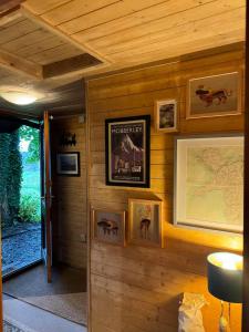 a room with a wall with pictures on it at Cosy Log Cabin in Machynlleth - Wales - Wifi & Parking in Machynlleth