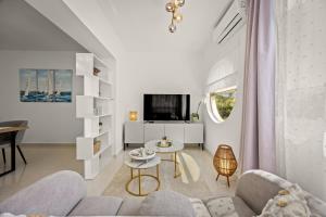 a living room with a couch and a table at New luxury apartment RABASOL in Rabac