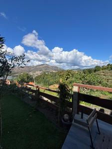 a bench sitting on top of a hill with a view at Casinha da Aurora in Pedorido +17 photos