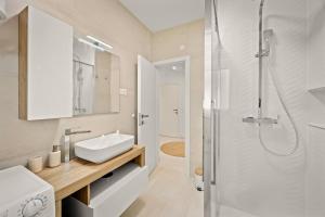 a bathroom with a sink and a shower at New luxury apartment RABASOL in Rabac +26 photos