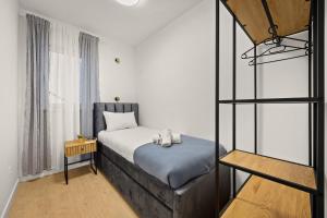 a small bedroom with a bed and a ladder at New luxury apartment RABASOL in Rabac