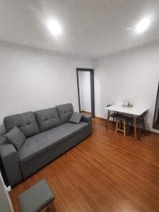 a living room with a couch and a table at AL-Andalus in Elvas