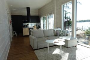 a living room with a couch and a table at Villa Leponiemi in Keuruu